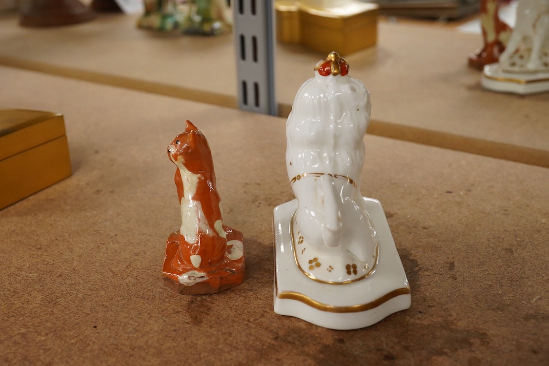 A Staffordshire lion with crown, c.1830-50 and a Staffordshire slipware cat, largest 8.5cm high (2)